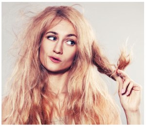 Young woman looking at split ends